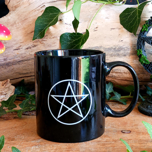 Enjoy your favourite tea or coffee with this striking Black Pentacle Ceramic Mug, featuring a beautiful and intricate Pentacle design. With its simple black finish and mystical symbolism, this mug makes a wonderful addition to any Wiccan or Pagan home.