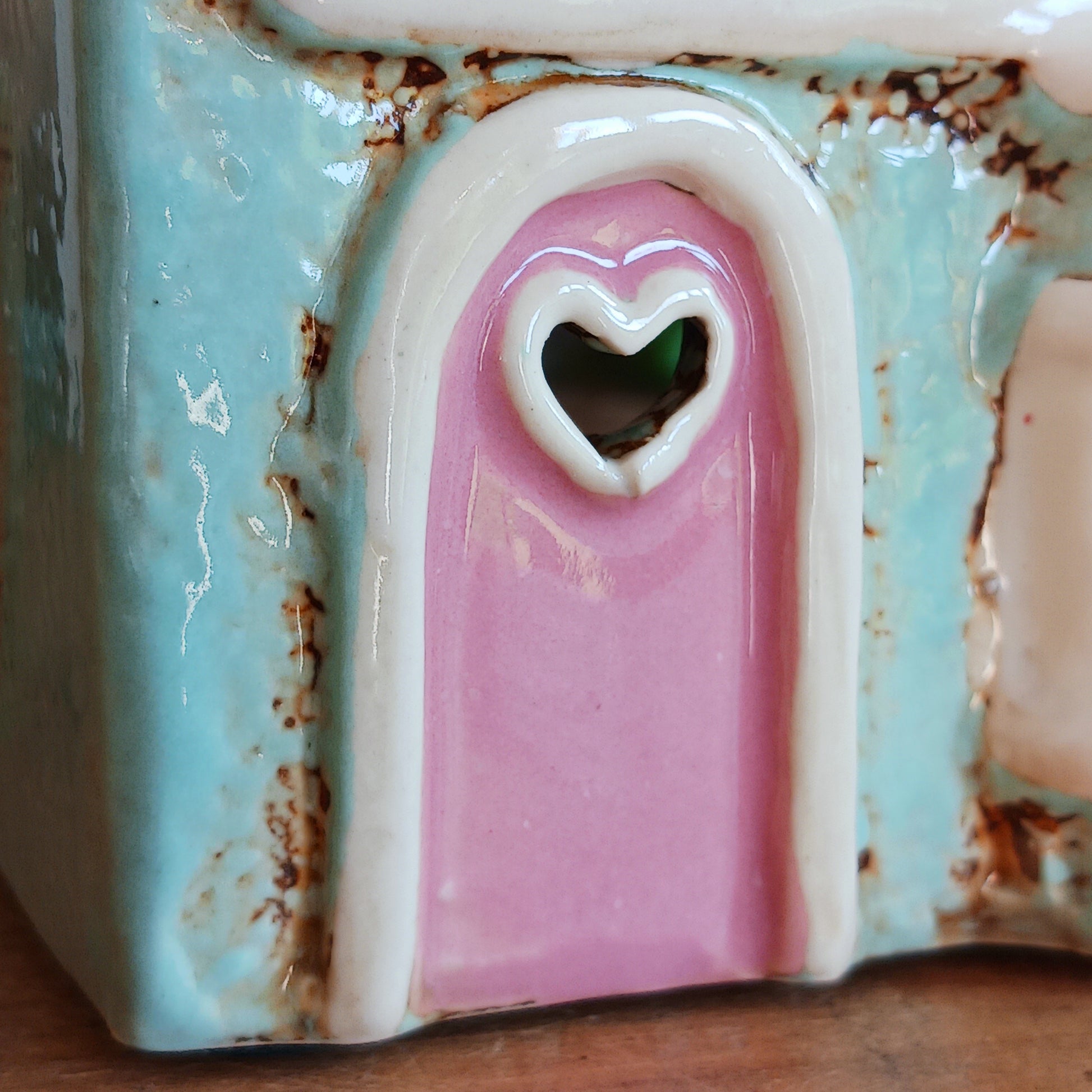 Transform your home into a warm and inviting sanctuary with the Village Pottery Gift Shop Tealight Holder. Crafted from quality ceramic, this charming piece creates a cosy, nostalgic glow when lit with a tealight. More than just a candle holder, it doubles as a delightful decorative ornament for your coffee table, shelf, or windowsill.