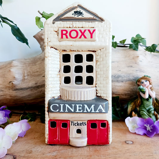 Step into a twilight screening where candlelight flickers like scenes upon an unseen reel. The Shudehill Village Pottery Roxy Cinema tealight house is crafted from ceramic, casting a soft glow through its windows to evoke a nostalgic yet enchanted village night.