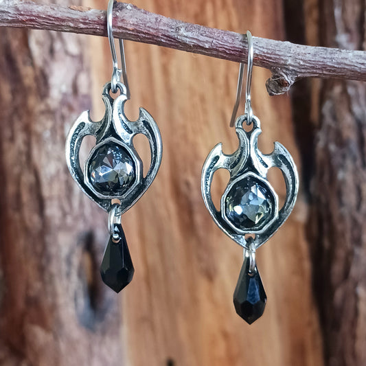 Experience timeless elegance with our Enchanting Baroque Earrings. Handcrafted with meticulous attention to detail, these earrings showcase intricate designs inspired by the romance and mystery of the Baroque era. Each piece is adorned with fine Austrian cut crystals that sparkle with captivating brilliance, reflecting light like moonlight on a tranquil night. 