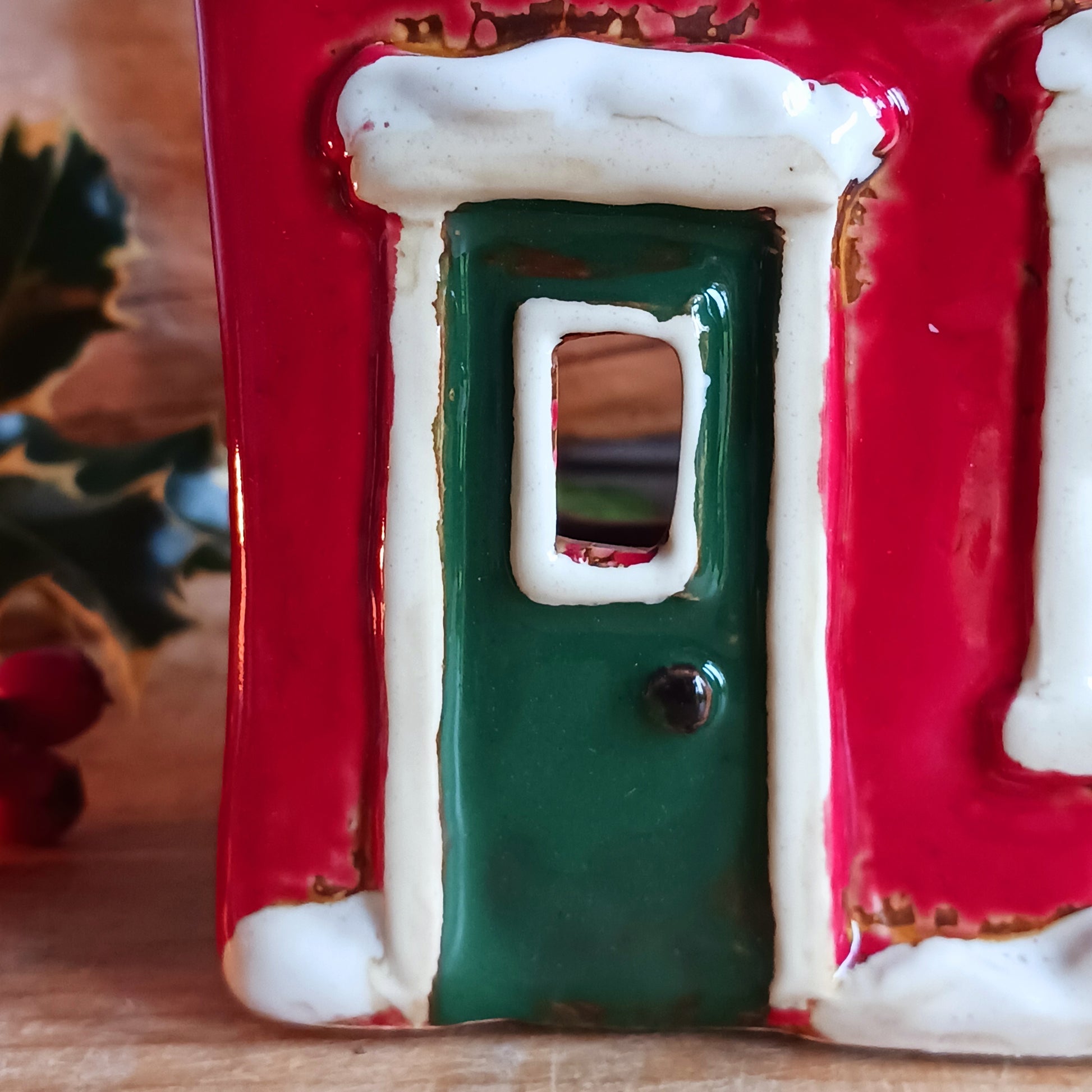 Bring the warmth and magic of Christmas into your home with this handcrafted Christmas Wreath House Tealight Holder from the Village Pottery collection. Made from high-quality ceramic and decorated with a classic wreath and rustic detailing, this piece evokes the charm of a snowy winter’s evening.