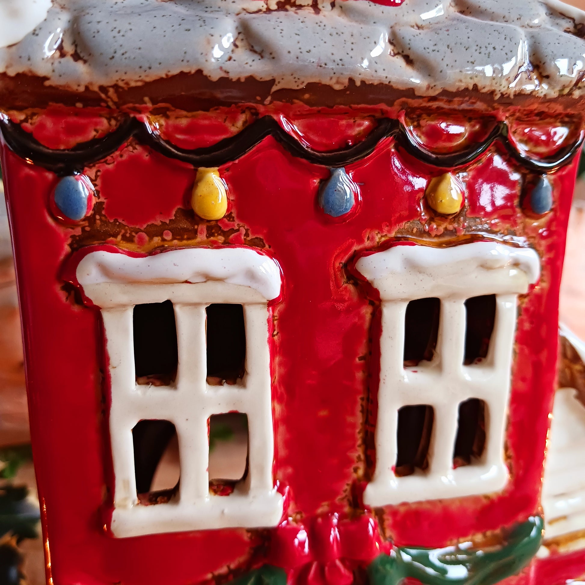 Bring the warmth and magic of Christmas into your home with this handcrafted Christmas Wreath House Tealight Holder from the Village Pottery collection. Made from high-quality ceramic and decorated with a classic wreath and rustic detailing, this piece evokes the charm of a snowy winter’s evening.