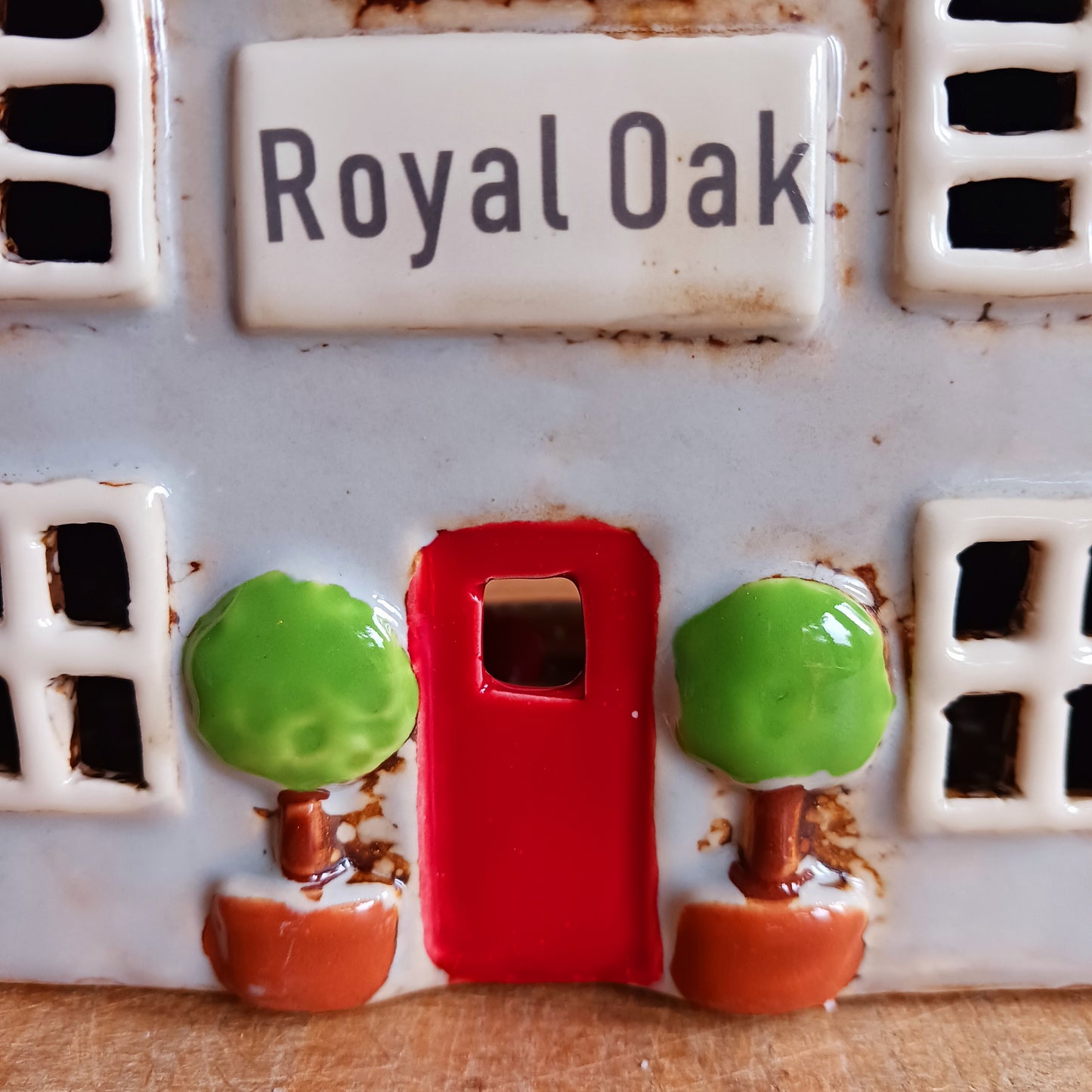Bring the charm of traditional village life into your home with the Royal Oak Pub Ceramic Tealight Holder. Handcrafted in the Village Pottery workshop, this timeless piece features intricate detailing and rustic finishes inspired by a classic village pub.