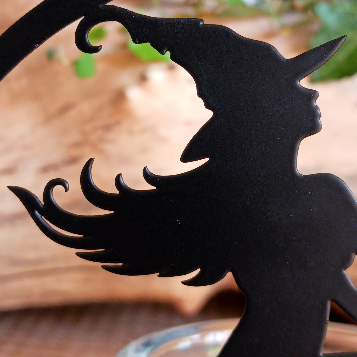Illuminate your space with the mystical allure of Witch by Moonlight. Crafted from black-coated iron and glass, this enchanting T-light holder depicts the classic silhouette of a witch soaring across a glowing full moon. A tribute to freedom, transformation, and the deep feminine magic within us all, it radiates both mystery and beauty.