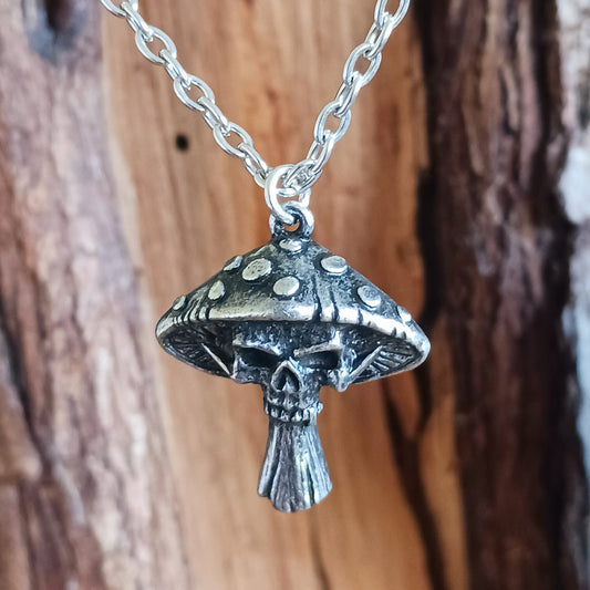 Bold, mystical, and slightly dangerous, the Death Cap Pendant draws inspiration from the legendary poisonous mushroom. Handcrafted in fine pewter, this striking pendant merges the natural form of a toadstool with a sinister skull motif, creating a statement piece that evokes folklore, witchcraft, and the darker side of nature.