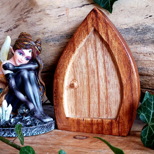 Welcome a touch of woodland magic into your space with this Fairy Door Woodcarving, a beautifully handcrafted piece inspired by folklore and nature. Each door is carved from natural wood using traditional techniques, making every one unique and full of character.