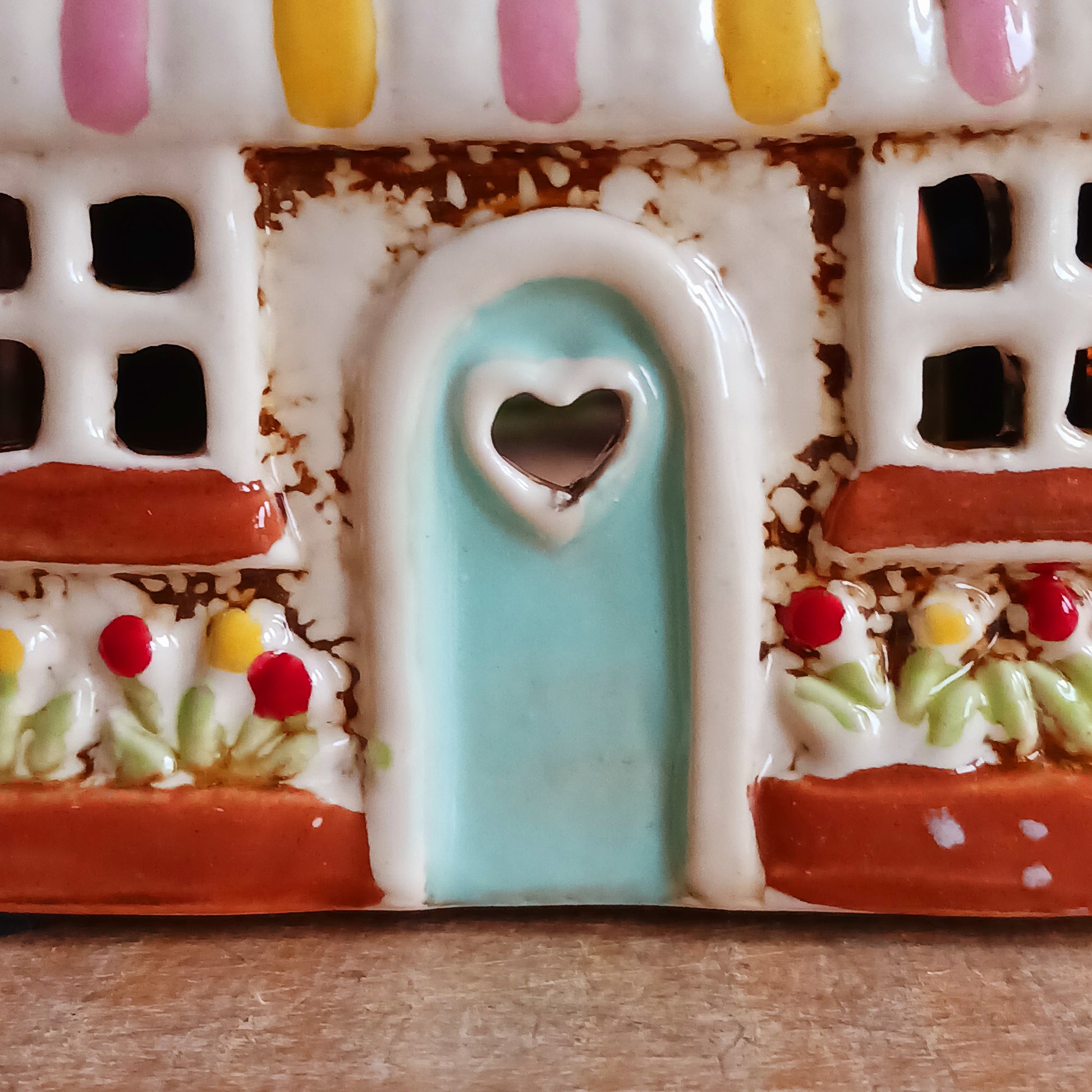 Handcrafted in the Village Pottery workshop, this Florist Tealight Holder is a true collectible from the Shudehill Collection. Made from fine ceramic with intricate detailing, it captures the nostalgic charm of a festive florist shop in a snow-dusted winter village scene.