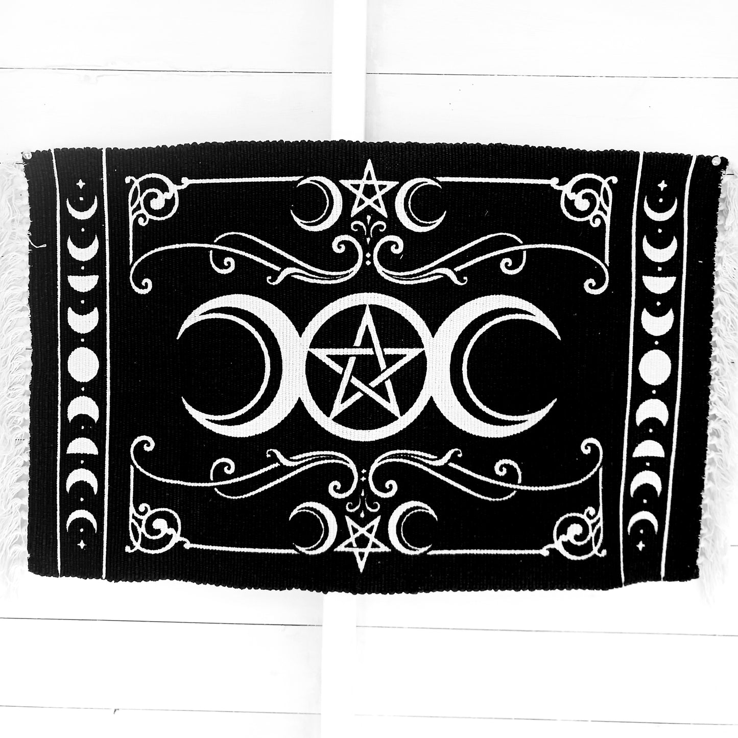 Invoke the sacred power of the lunar goddess with this Alchemy Gothic handwoven rug, beautifully depicting the eternal archetypes of Maiden, Mother, and Crone. Aligned with the moon's phases, this mystical tapestry blends symbolic femininity with ancient pagan wisdom, framed by the powerful elemental pentacle.