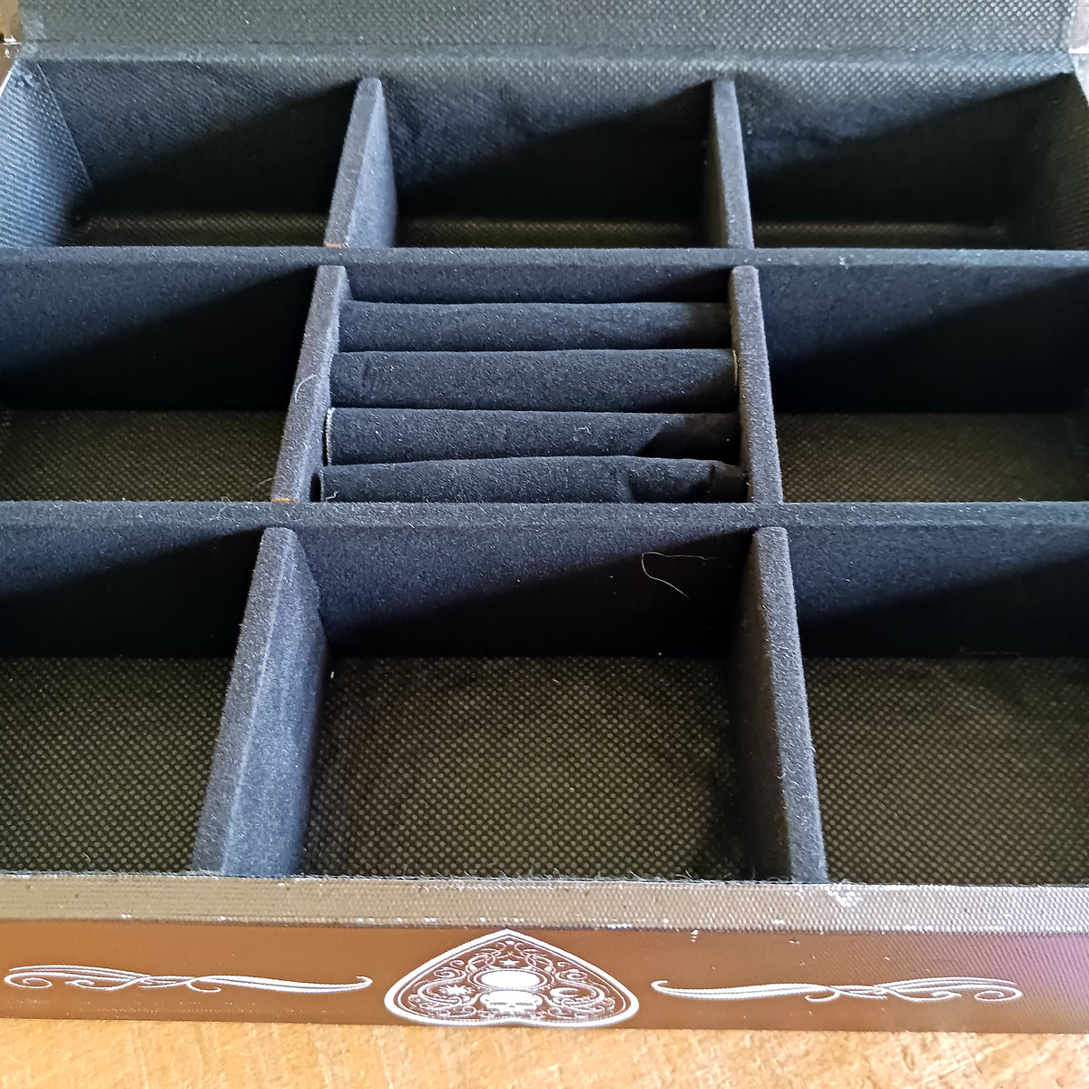 Add a touch of gothic and vintage occult style to your dressing table with this large spirit board jewellery box. Designed with a striking black background, white baroque artwork and traditional spirit-board-inspired details, it makes an unusual storage piece for anyone drawn to mystical and alternative décor.