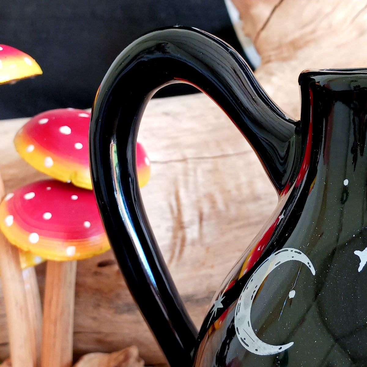 Add a touch of celestial magic to tea time with this striking black ceramic teapot, beautifully decorated with moon and star details and finished with a statement star-shaped lid.