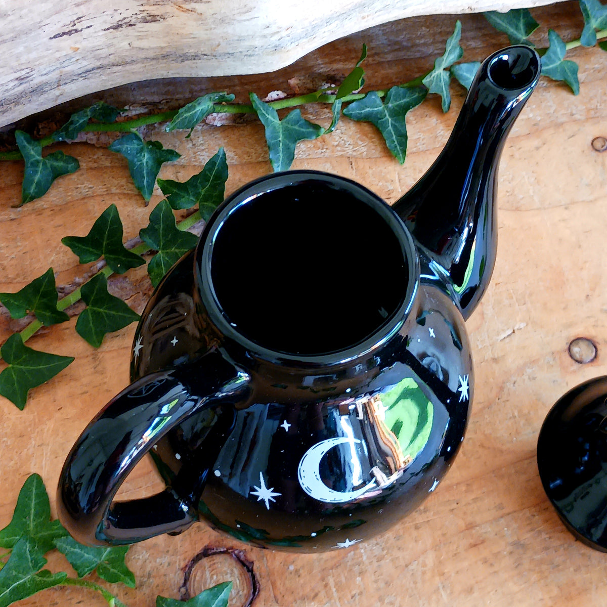 Add a touch of celestial magic to tea time with this striking black ceramic teapot, beautifully decorated with moon and star details and finished with a statement star-shaped lid.