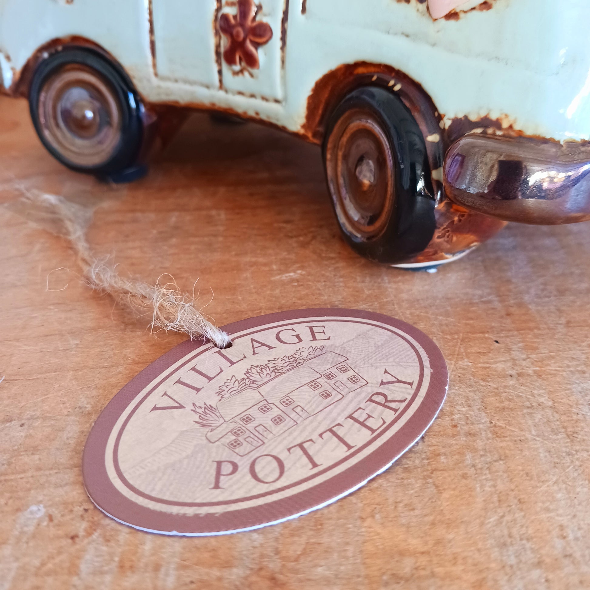 From the enchanted lanes of Village Pottery comes this Aqua VW Campervan Money Box, a charming ceramic treasure crafted for dreamers and wanderers alike. Measuring 11 x 18.5 x 10cm, this delightful piece captures the spirit of adventure with its soft aqua glaze, vintage VW Campervan design, and hand-painted detailing that feels kissed by fairy dust.