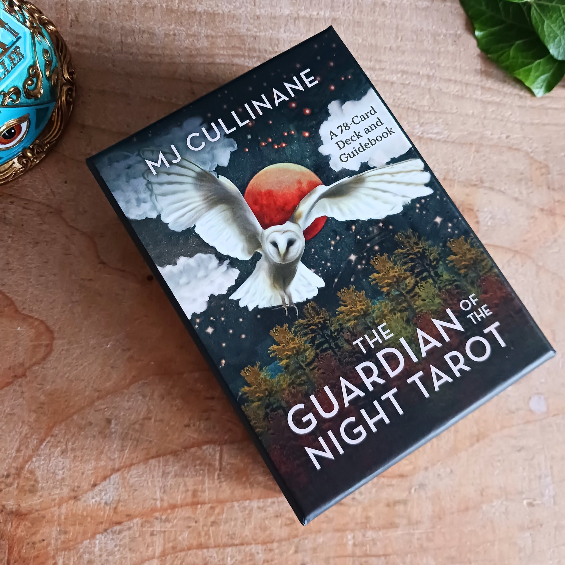 Step into the wisdom of the night with The Guardian of the Night Tarot Deck by MJ Cullinane, a beautifully illustrated 78-card tarot deck with a companion guidebook. This unique deck uses powerful animal symbolism from cultures around the world to illuminate light within darkness, offering guidance during times of uncertainty, transformation, and introspection.