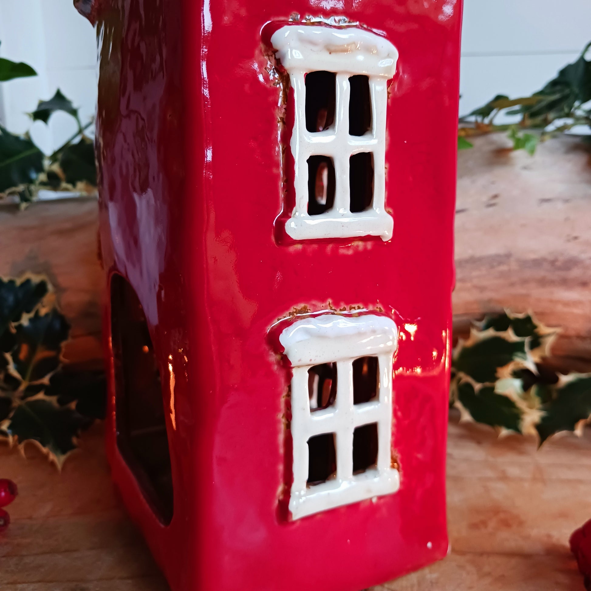 Bring the warmth and magic of Christmas into your home with this handcrafted Christmas Wreath House Tealight Holder from the Village Pottery collection. Made from high-quality ceramic and decorated with a classic wreath and rustic detailing, this piece evokes the charm of a snowy winter’s evening.