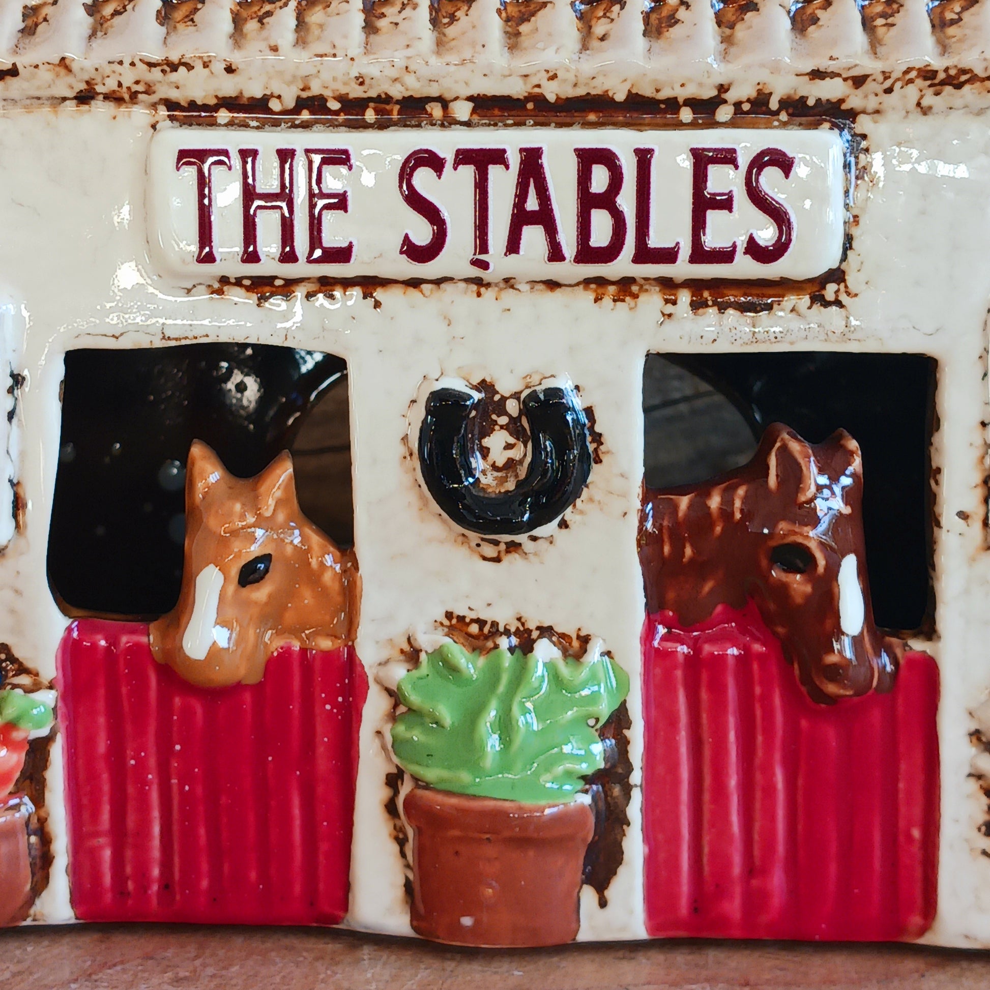Nestled at the edge of a quiet enchanted village, The Stables tealight house by Village Pottery glows with a soft, grounding warmth. Crafted from ceramic and measuring 17x8x8cm, this rustic stable invites candlelight to flicker through its windows like a lantern for wandering spirits and kindred souls.