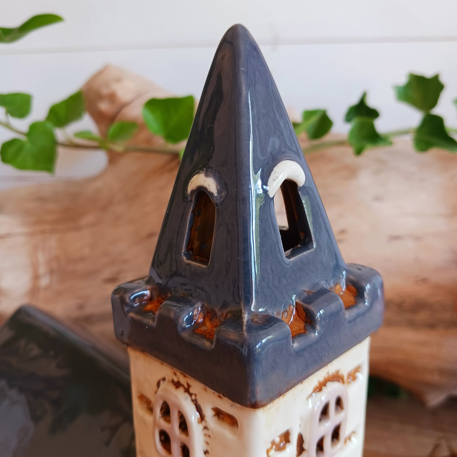 Add timeless charm to your home with the Village Pottery Steeple Church Tealight Holder. Beautifully hand-finished, each ceramic piece is unique and full of character. When a tealight is placed inside, a warm, cosy glow shines through the delicate church windows, creating a magical ambiance. 
