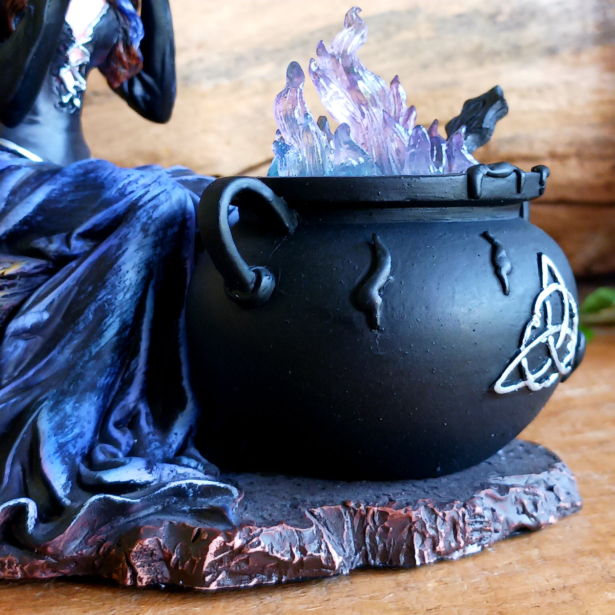 Meet Alvina, a captivating hand-painted witch figurine seated peacefully on a rustic log with her enchanting owl companion. Dressed in a flowing blue gown with long brown hair, Alvina has a mysterious yet charming presence that will appeal to lovers of witches, fantasy and magical décor.