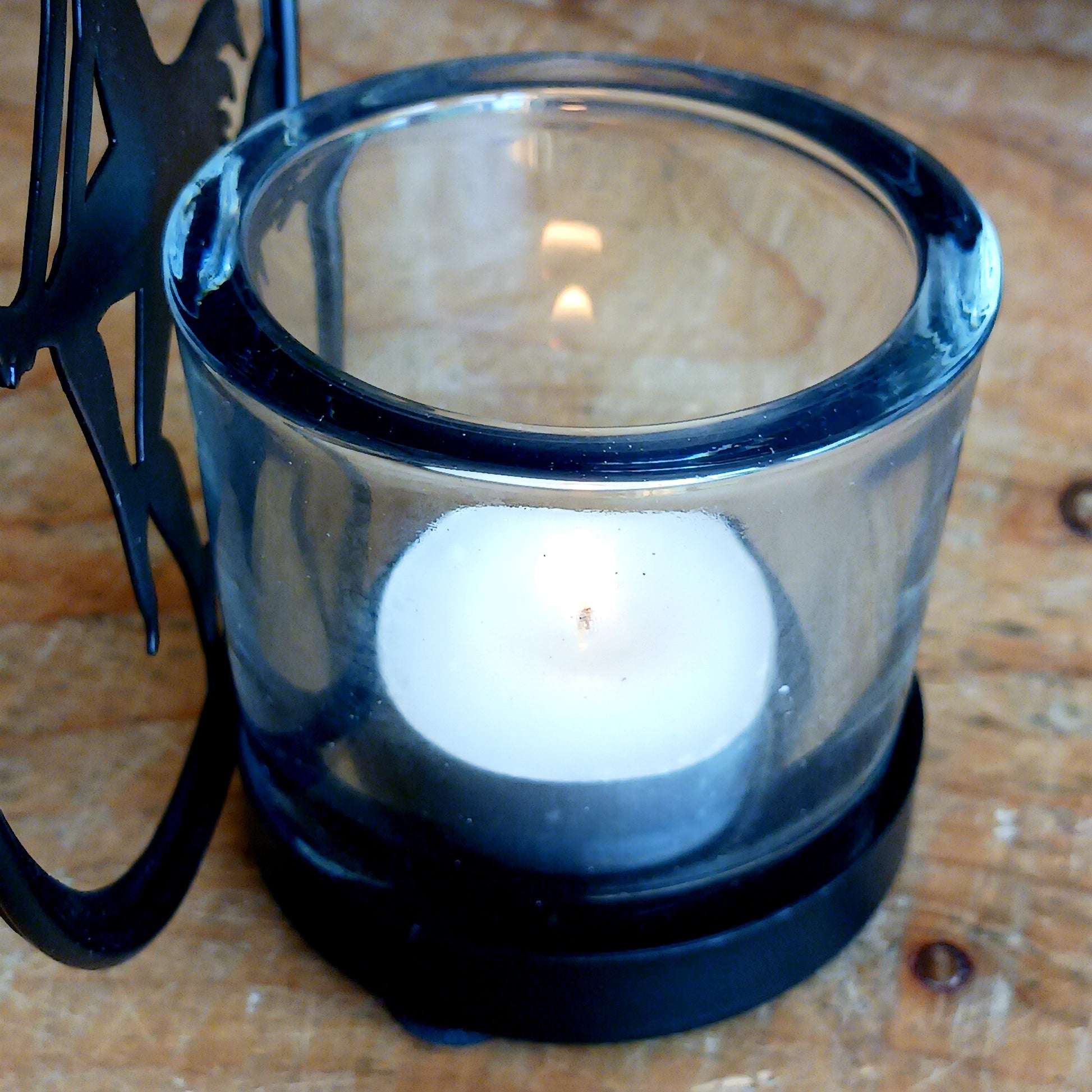 Illuminate your space with the mystical allure of Witch by Moonlight. Crafted from black-coated iron and glass, this enchanting T-light holder depicts the classic silhouette of a witch soaring across a glowing full moon. A tribute to freedom, transformation, and the deep feminine magic within us all, it radiates both mystery and beauty.