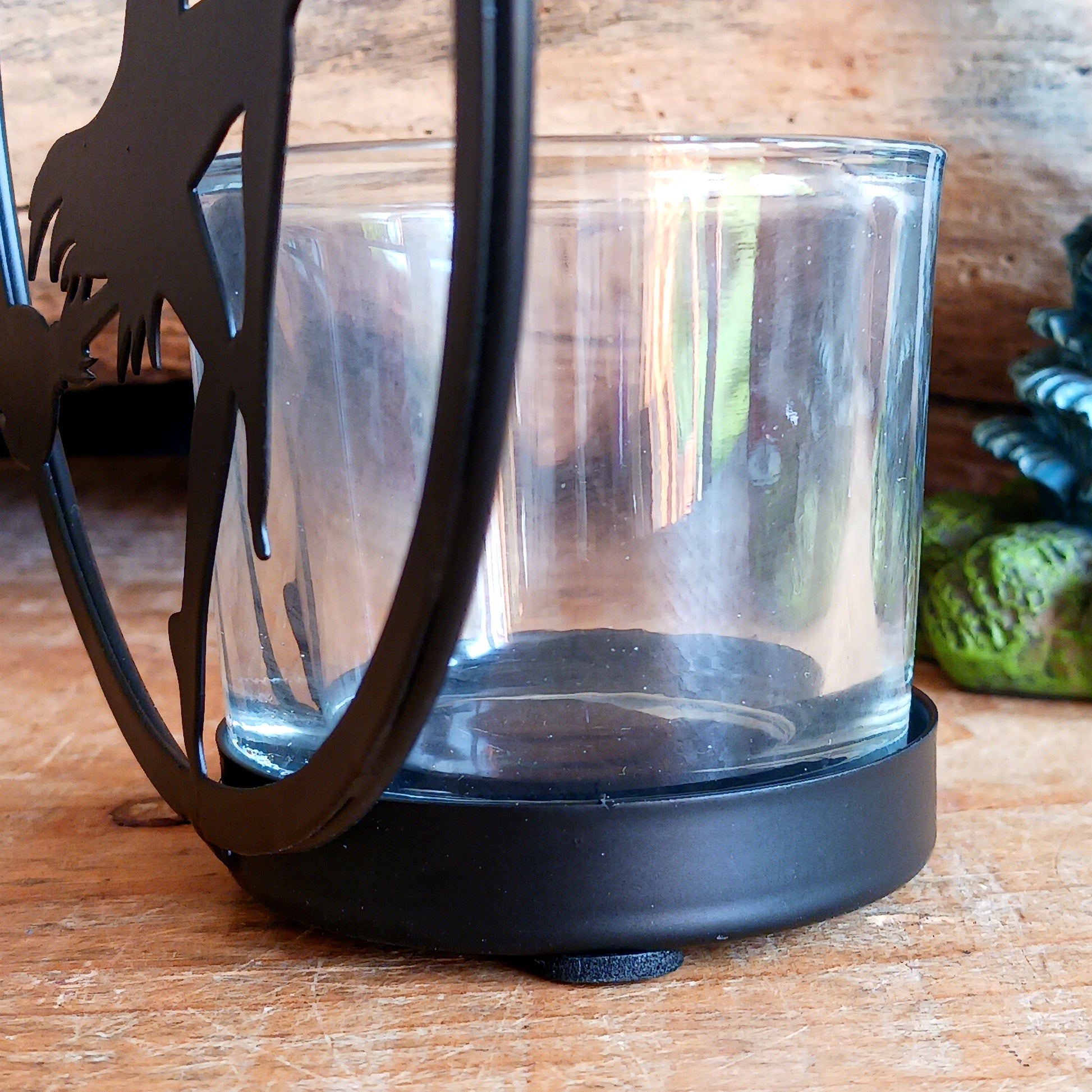 Illuminate your space with the mystical allure of Witch by Moonlight. Crafted from black-coated iron and glass, this enchanting T-light holder depicts the classic silhouette of a witch soaring across a glowing full moon. A tribute to freedom, transformation, and the deep feminine magic within us all, it radiates both mystery and beauty.