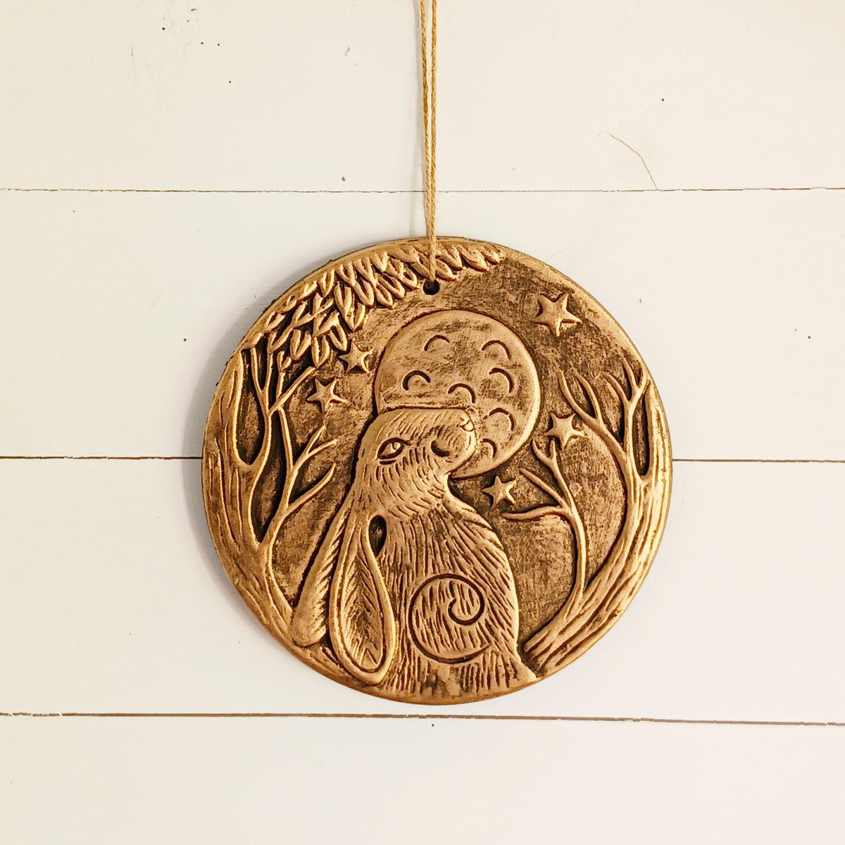 Add a touch of mystical woodland charm to your home with this beautiful Lisa Parker Moon Gazing Hare Terracotta Plaque. Featuring a striking hare gazing towards the moon, this circular decorative plaque has a distinctive copper-effect finish that gives it a warm, antique-inspired appearance.