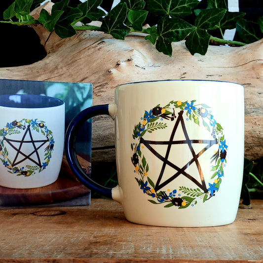 Celebrate the magic of the seasons with this Solstice Wreath Botanical Pentagram Mug, designed for those who love mystical décor, nature-inspired artwork and cosy rituals. Featuring a beautiful botanical pentagram wreath, this enchanting mug is perfect for sipping warming coffees, herbal teas or rich hot chocolates throughout the colder months.