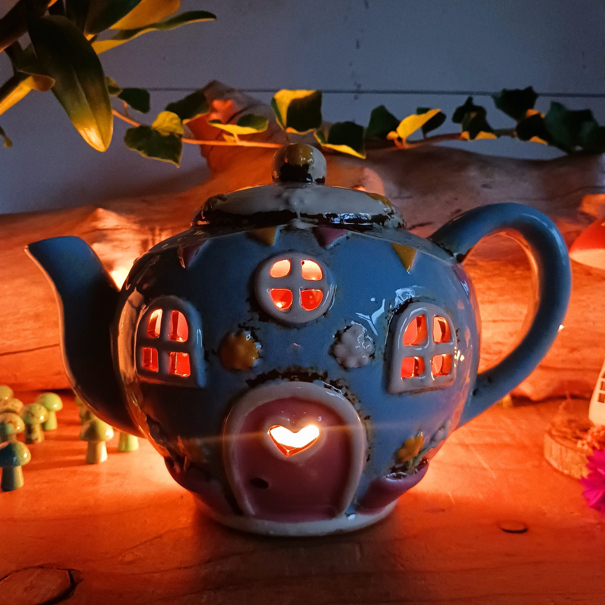 Create a warm and cosy atmosphere in your home with this charming Round Teapot Tealight Holder from the Village Pottery Collection. Crafted in a unique teapot shape, this ceramic tealight holder makes a delightful decorative piece for shelves, windowsills, or side tables. Simply place a tealight inside to enjoy a soft, glowing ambience.