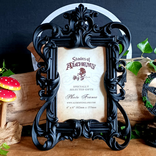 Add a touch of dark elegance to your home with this ornate Black Rococo Photo Frame. Inspired by the opulence of a bygone era, this decorative resin frame features elaborate scrollwork, flowing curves and a dramatic black finish, creating a striking statement piece for gothic, vintage and alternative interiors.