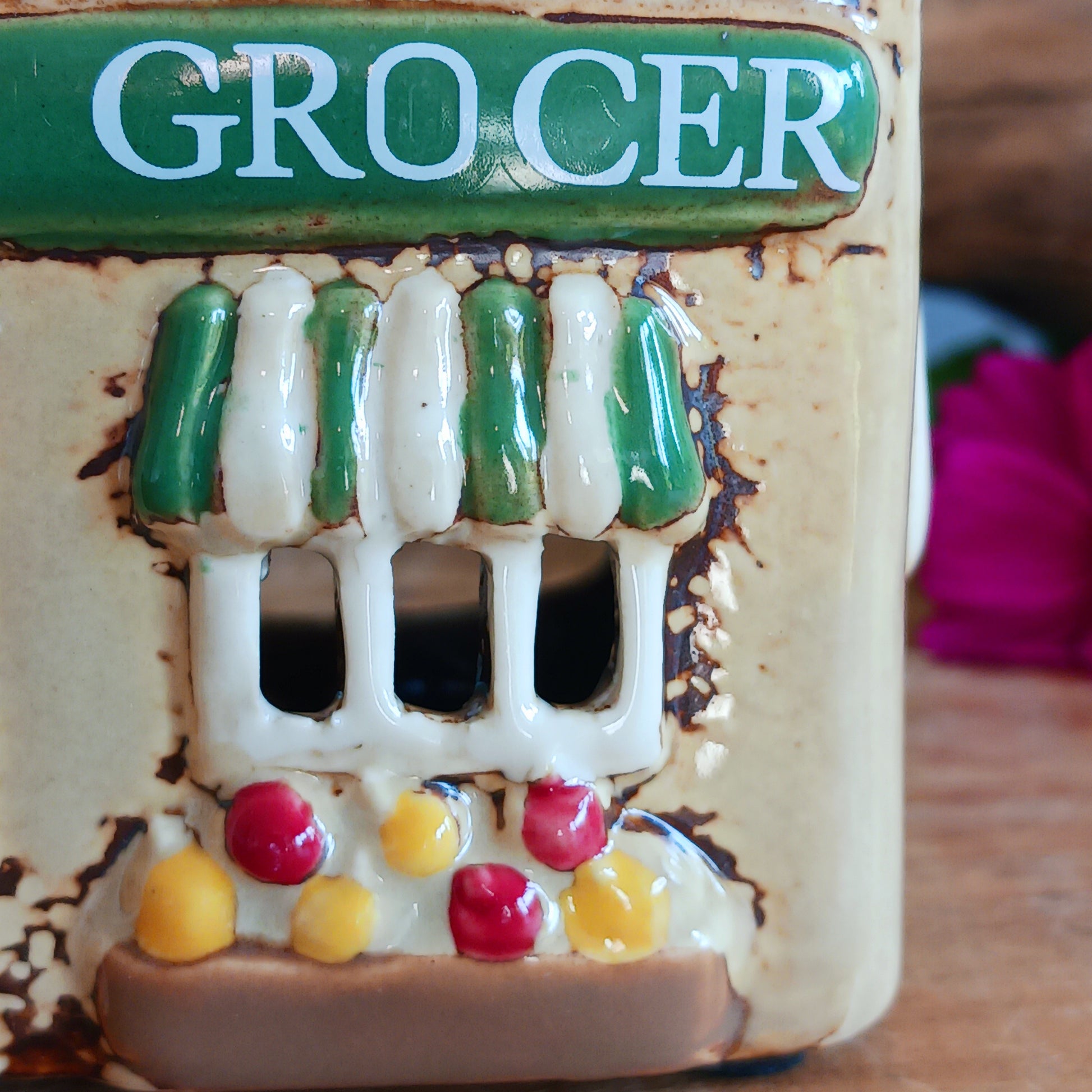 Illuminate your home with the charming Village Pottery Green Grocers Shop Tealight Holder. Handcrafted with a rustic green finish, this cosy piece adds warmth and ambience to any room. Perfect for tealights or simply as a decorative ornament, it’s a delightful addition to shelves, windowsills, or coffee tables. Pair with other pieces from the Village Pottery Collection to create your own quaint, decorative village.