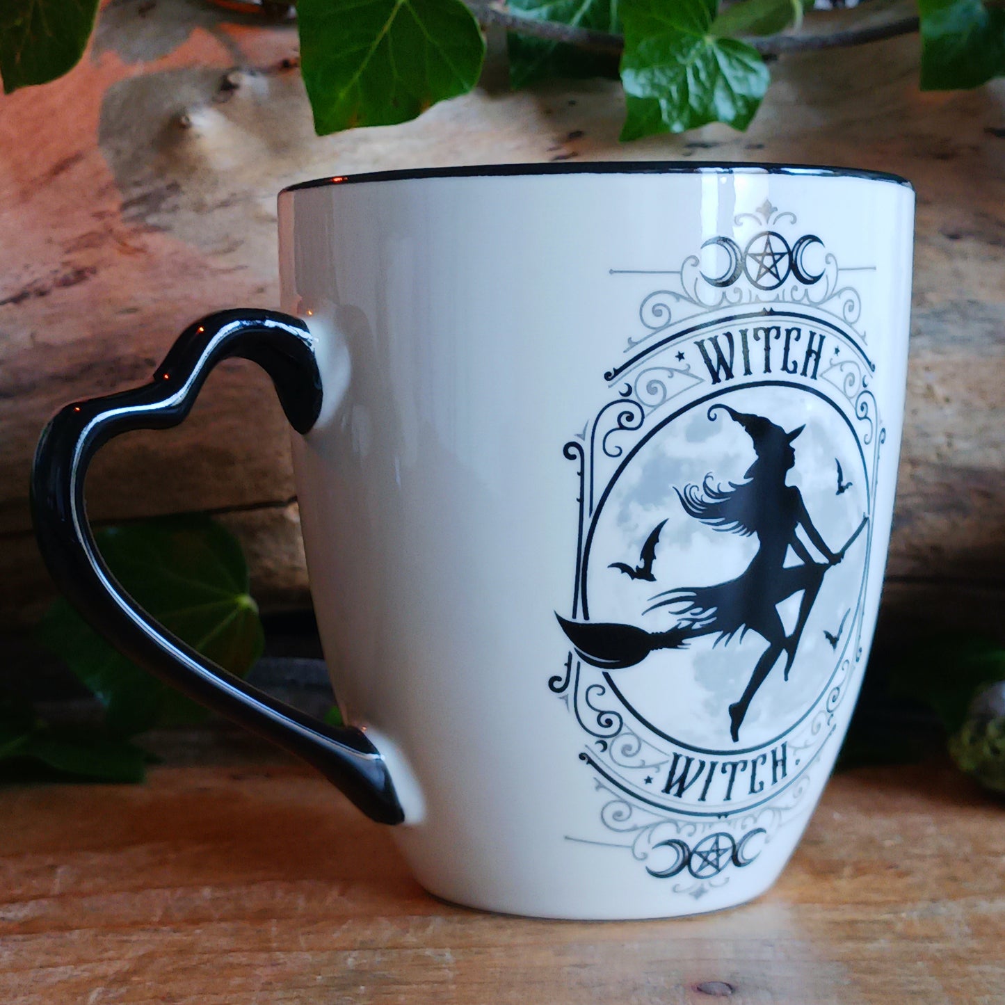 When the moon rises and the stars awaken, the Midnight Witch takes flight. Glide through twilight skies with this enchanting Witch Mug by Alchemy, a perfect blend of gothic charm and whimsical magic.
