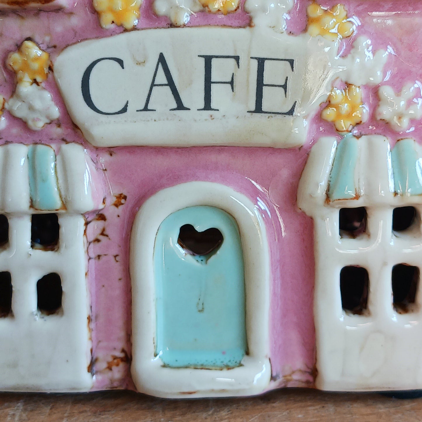 Illuminate your home with the charming Village Pottery Café Tealight Holder. Handcrafted with a rustic pink finish, this cosy piece adds warmth and ambience to any room. Perfect for tealights or simply as a decorative ornament, it’s a delightful addition to shelves, windowsills, or coffee tables. Pair with other pieces from the Village Pottery Collection to create your own quaint, decorative village.