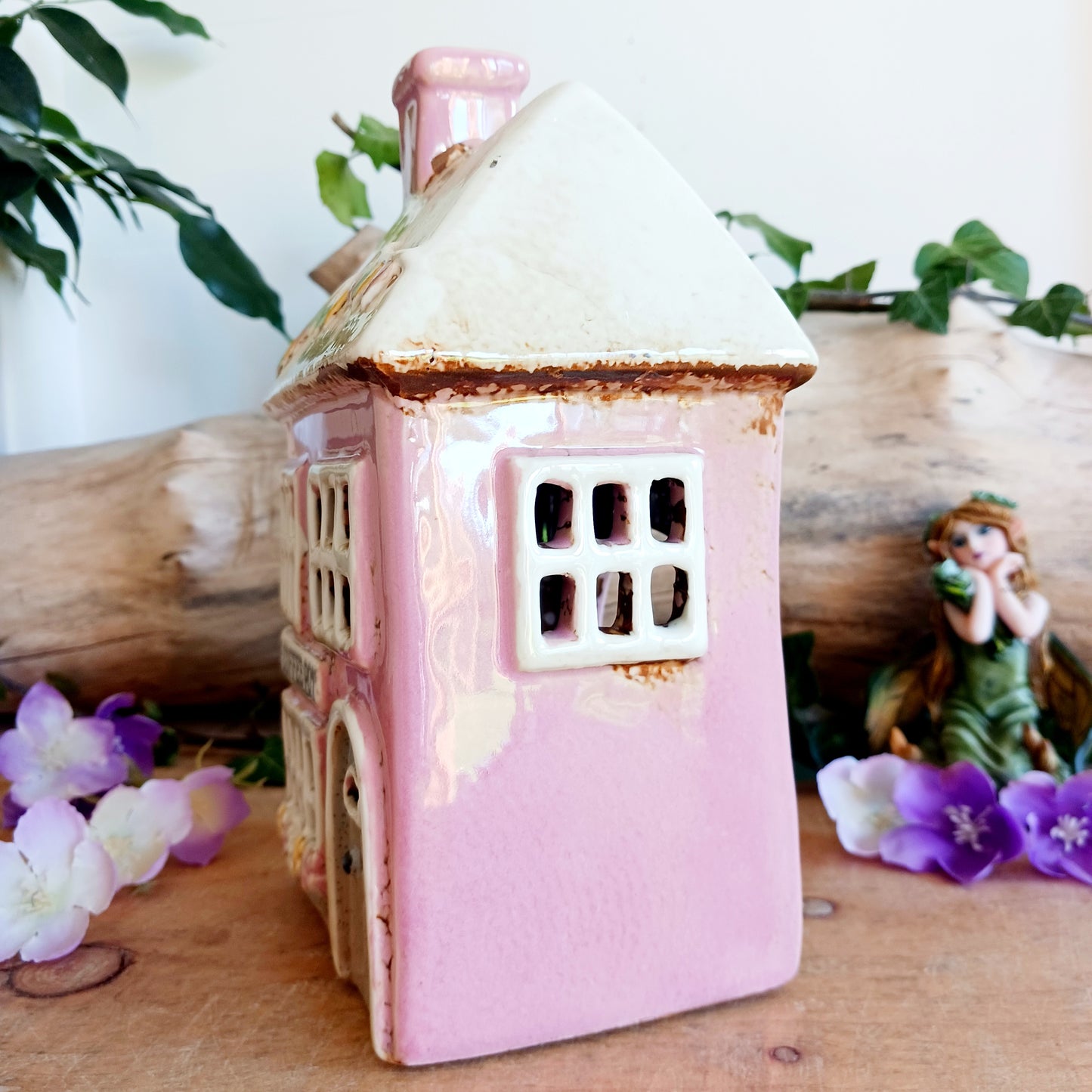 A comforting glow brews within the Coffee Pot Shop, where candlelight flickers like steam rising from a warm cup in a quiet enchanted village. This Shudehill Village Pottery tealight house is crafted from ceramic, casting a soft, golden light through its windows to create a scene of calm and gentle magic.