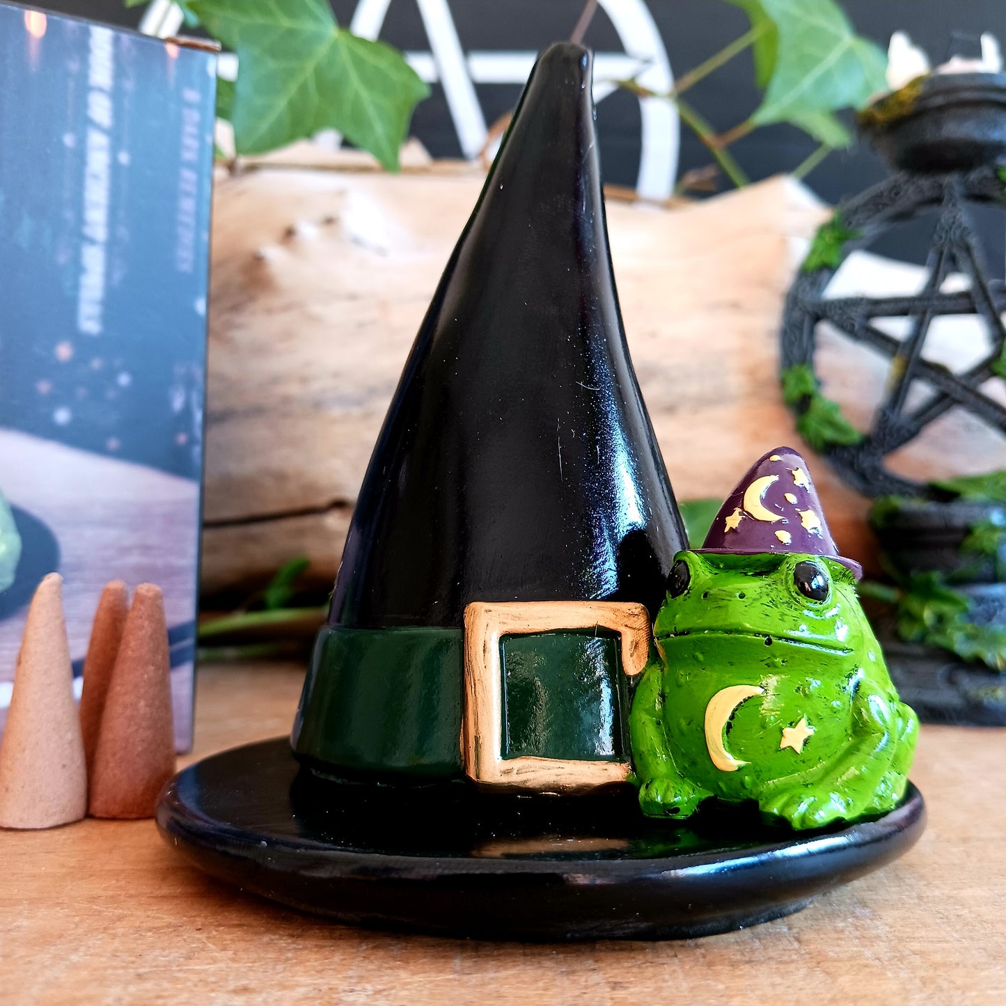 Add a touch of playful magic to your home with this charming Magic Toad & Witch Hat Incense Cone Holder. Made from resin, this quirky incense burner features a classic witch’s hat accompanied by a cute toad, creating a fun and mystical piece of witchy home décor.
