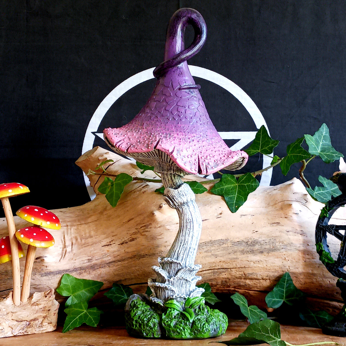 Bring a touch of magic and whimsical charm to your home with Twizzle Tumblethorne, a wonderfully quirky purple mushroom sculpture perfect for lovers of fantasy, fairies and nature-inspired decor.