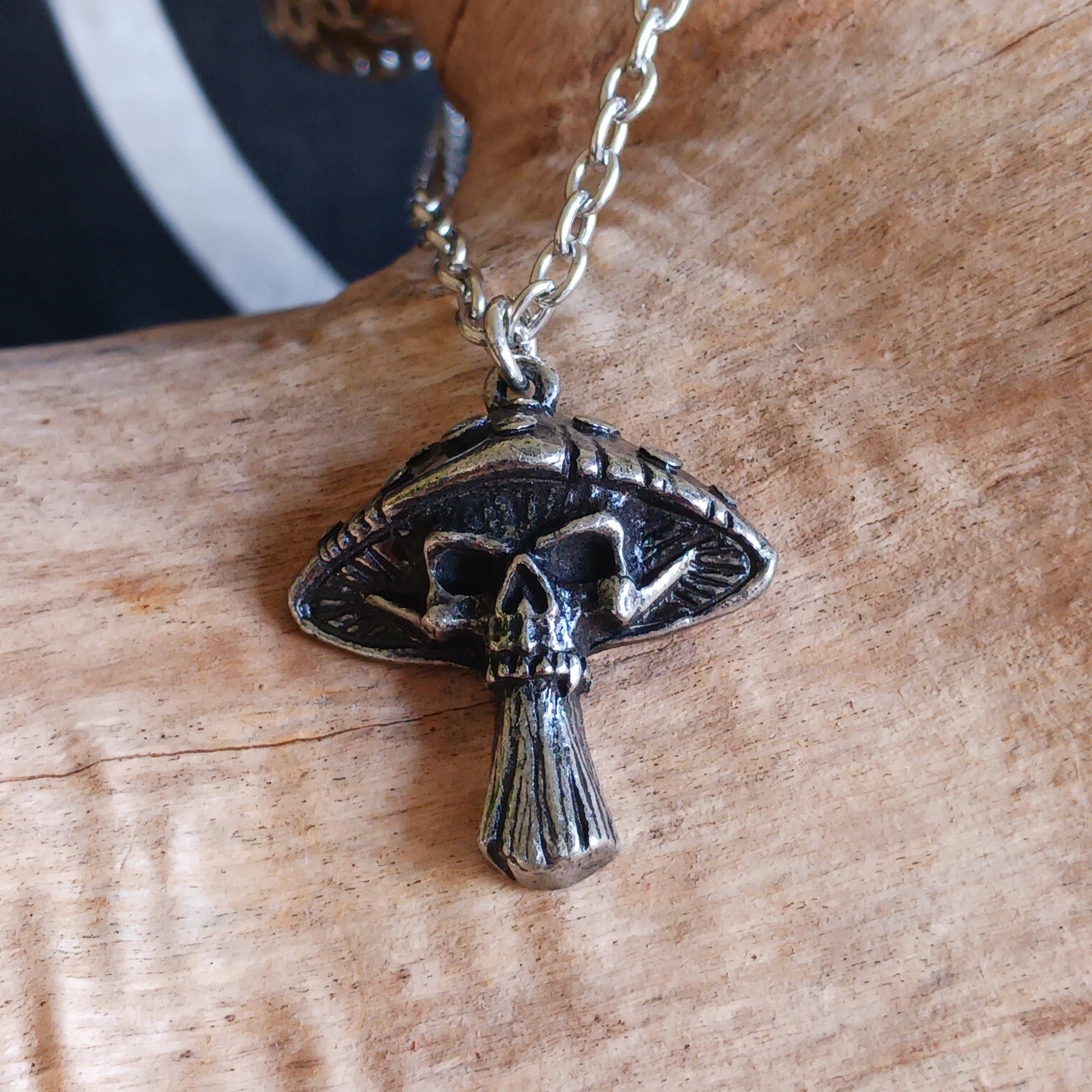 Bold, mystical, and slightly dangerous, the Death Cap Pendant draws inspiration from the legendary poisonous mushroom. Handcrafted in fine pewter, this striking pendant merges the natural form of a toadstool with a sinister skull motif, creating a statement piece that evokes folklore, witchcraft, and the darker side of nature.