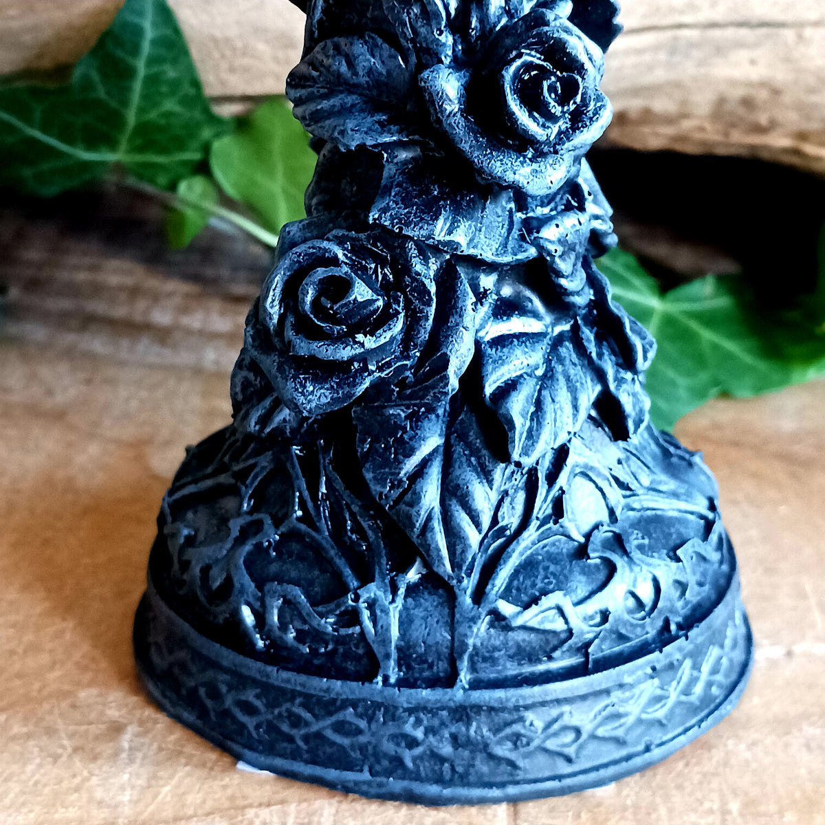 Add a touch of dark elegance to your home with the Midnight Rose Gothic Candlestick Holder. Beautifully crafted with a stone pillar design, this striking ornament features intricate black roses and dark vegetation, creating a mysterious gothic aesthetic that makes a statement in any room.