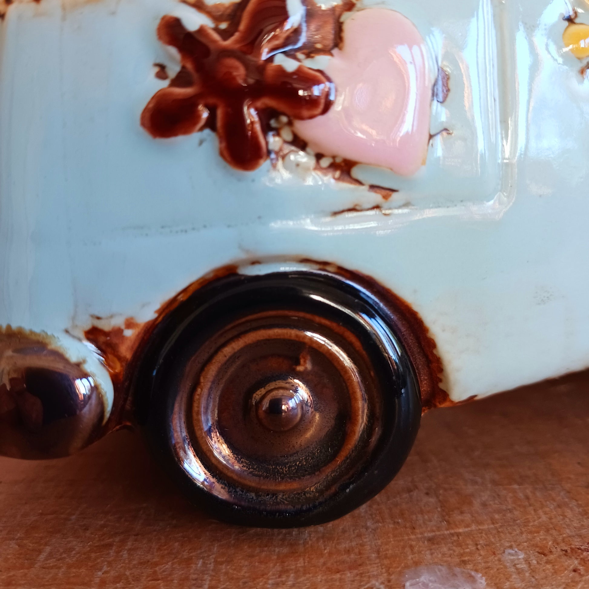 From the enchanted lanes of Village Pottery comes this Aqua VW Campervan Money Box, a charming ceramic treasure crafted for dreamers and wanderers alike. Measuring 11 x 18.5 x 10cm, this delightful piece captures the spirit of adventure with its soft aqua glaze, vintage VW Campervan design, and hand-painted detailing that feels kissed by fairy dust.