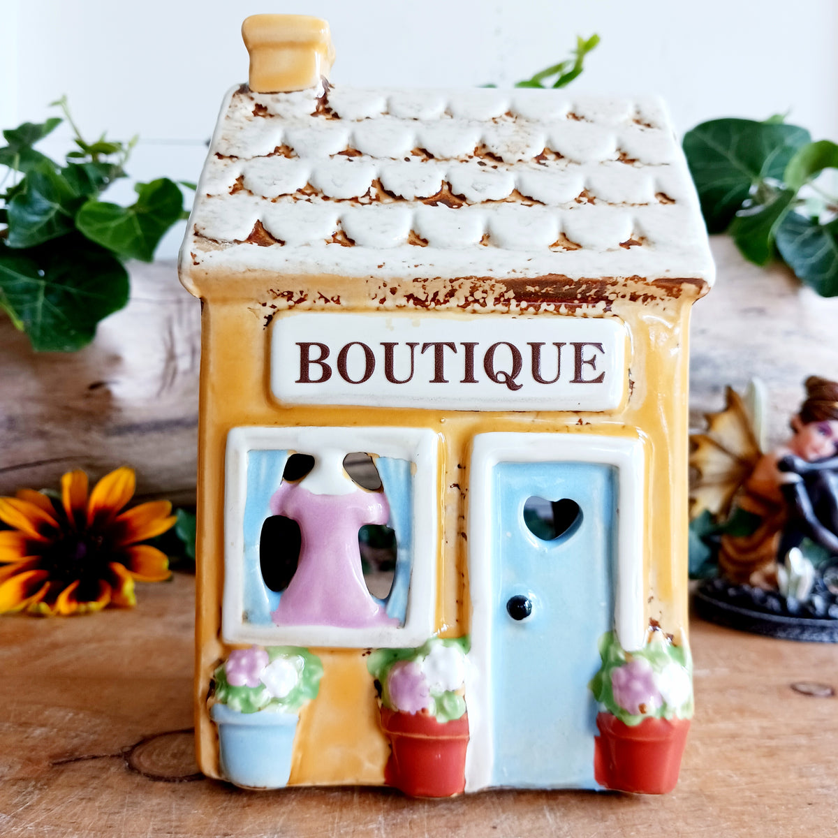 Bring a little village charm into your home with this delightful Village Pottery Boutique Tealight Holder. Hand-crafted in ceramic and beautifully hand-painted, this charming miniature shop makes a lovely decorative feature both with or without a candle.