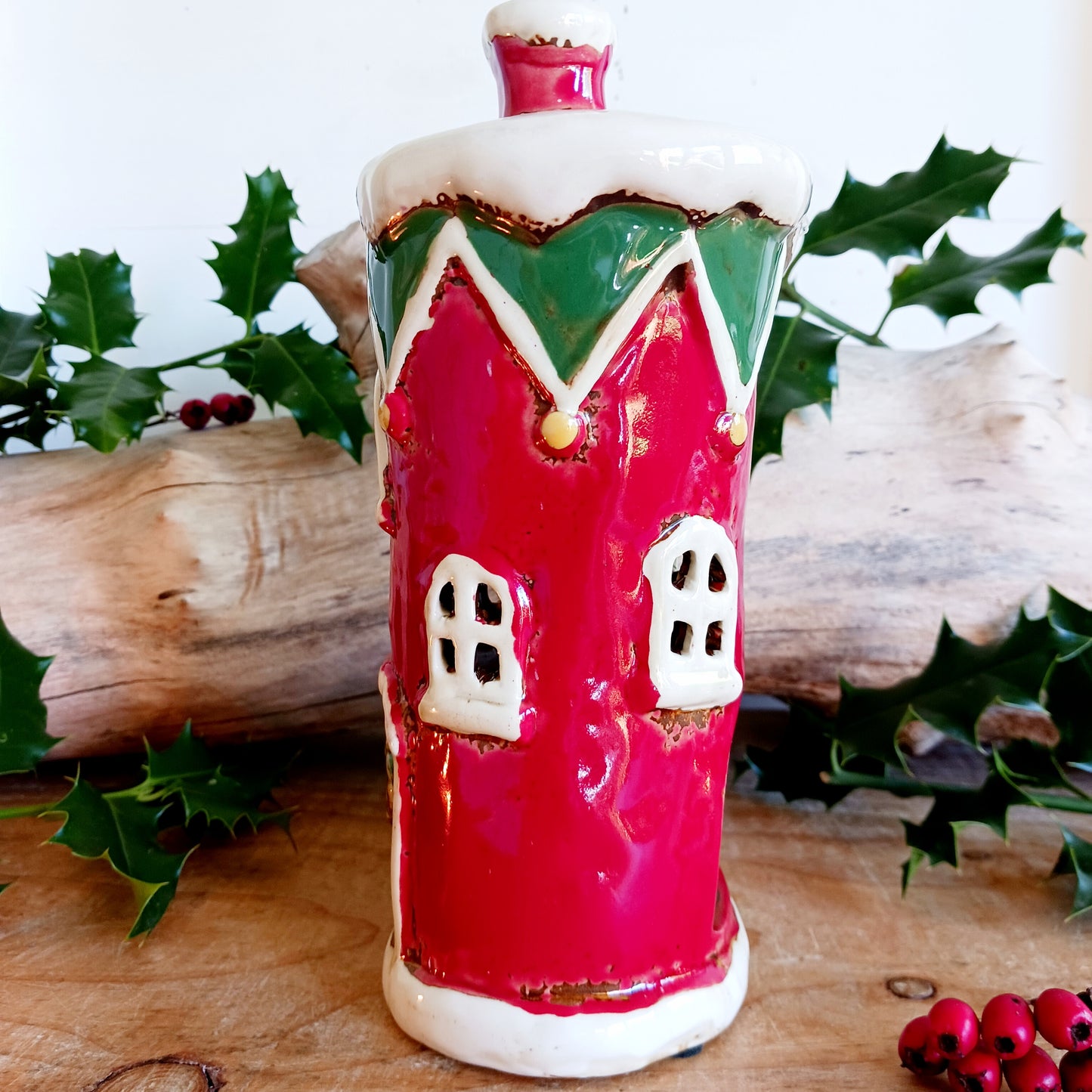 Step into the world of festive enchantment with the Village Pottery Christmas Elf Boot House Tealight Holder, a playful handcrafted ceramic creation bursting with Christmas spirit. Measuring 16 x 16 x 9.5 cm, this delightful piece takes the shape of a cheerful elf’s boot turned into a cosy little house, complete with twinkling windows and snowy details.