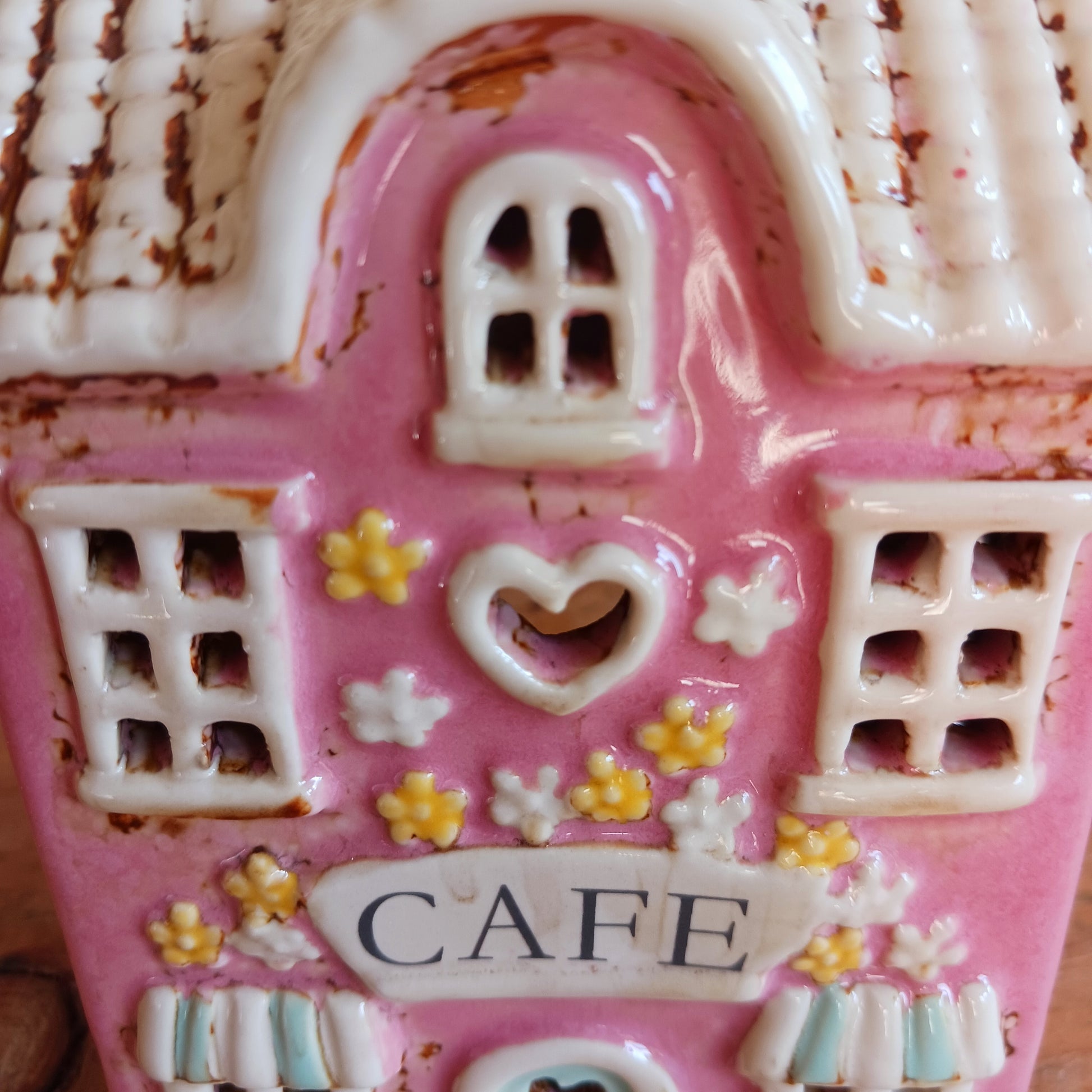 Illuminate your home with the charming Village Pottery Café Tealight Holder. Handcrafted with a rustic pink finish, this cosy piece adds warmth and ambience to any room. Perfect for tealights or simply as a decorative ornament, it’s a delightful addition to shelves, windowsills, or coffee tables. Pair with other pieces from the Village Pottery Collection to create your own quaint, decorative village.