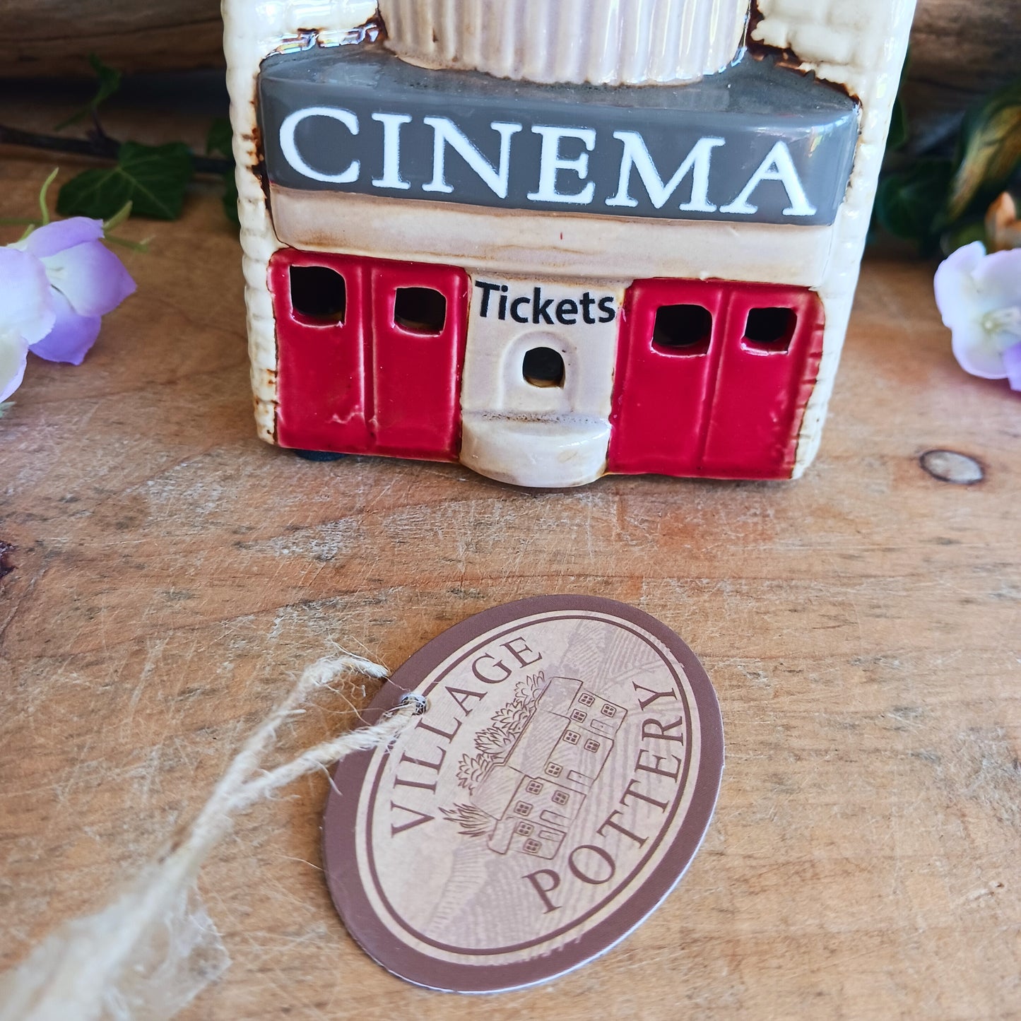 Step into a twilight screening where candlelight flickers like scenes upon an unseen reel. The Shudehill Village Pottery Roxy Cinema tealight house is crafted from ceramic, casting a soft glow through its windows to evoke a nostalgic yet enchanted village night.