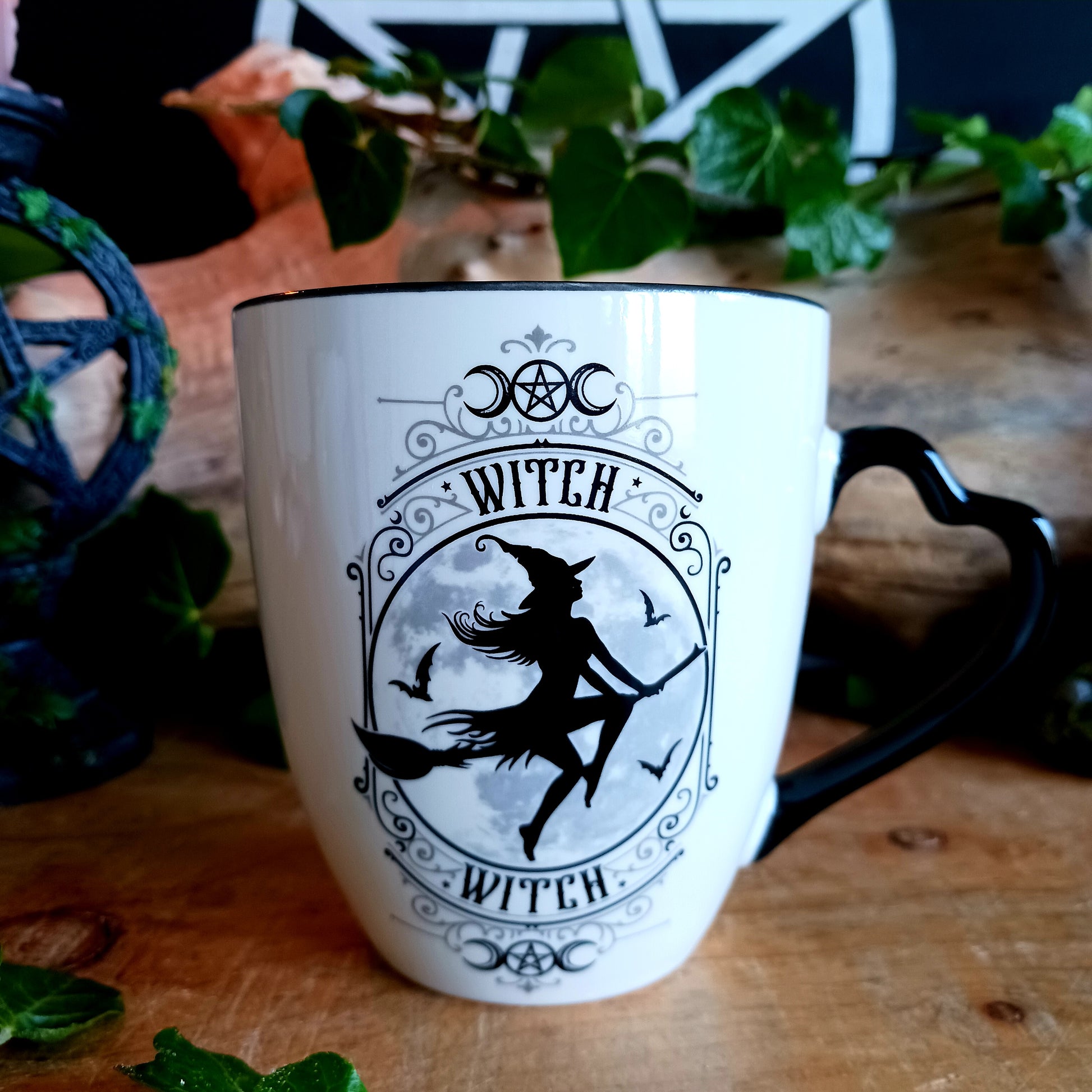 When the moon rises and the stars awaken, the Midnight Witch takes flight. Glide through twilight skies with this enchanting Witch Mug by Alchemy, a perfect blend of gothic charm and whimsical magic.