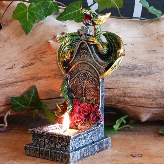 Bring a touch of mythical magic to your home with the Light of the Dragon Green Ornamental Tealight Holder. Featuring an enchanting green dragon coiled around a tombstone-style base, this intricately detailed candle holder is perfect for fantasy lovers and collectors of unusual home décor.