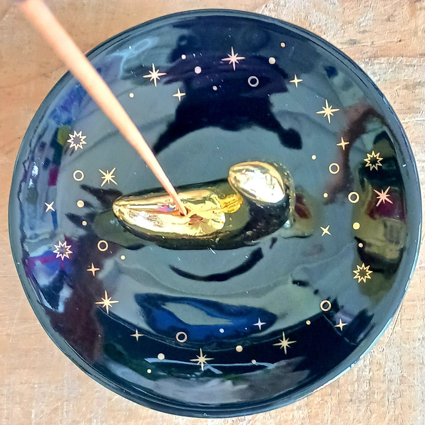 Harness the night’s enchantment with the Gold Crescent Moon Incense Stick Holder. Crafted from smooth ceramic, this elegant crescent-shaped holder captures falling ash with ease while your favourite incense releases its alluring aroma. Perfect for your altar, bedside table, or meditation space, it infuses every corner with a spellbinding, celestial energy.