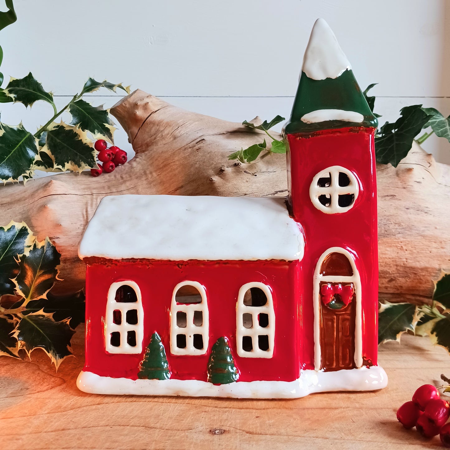 Bring festive warmth to your home with the Large Christmas Church Tealight Holder from the Village Pottery collection. This beautifully handcrafted ceramic piece features rustic detailing, evoking the charm of a snow-covered church glowing softly with candlelight.