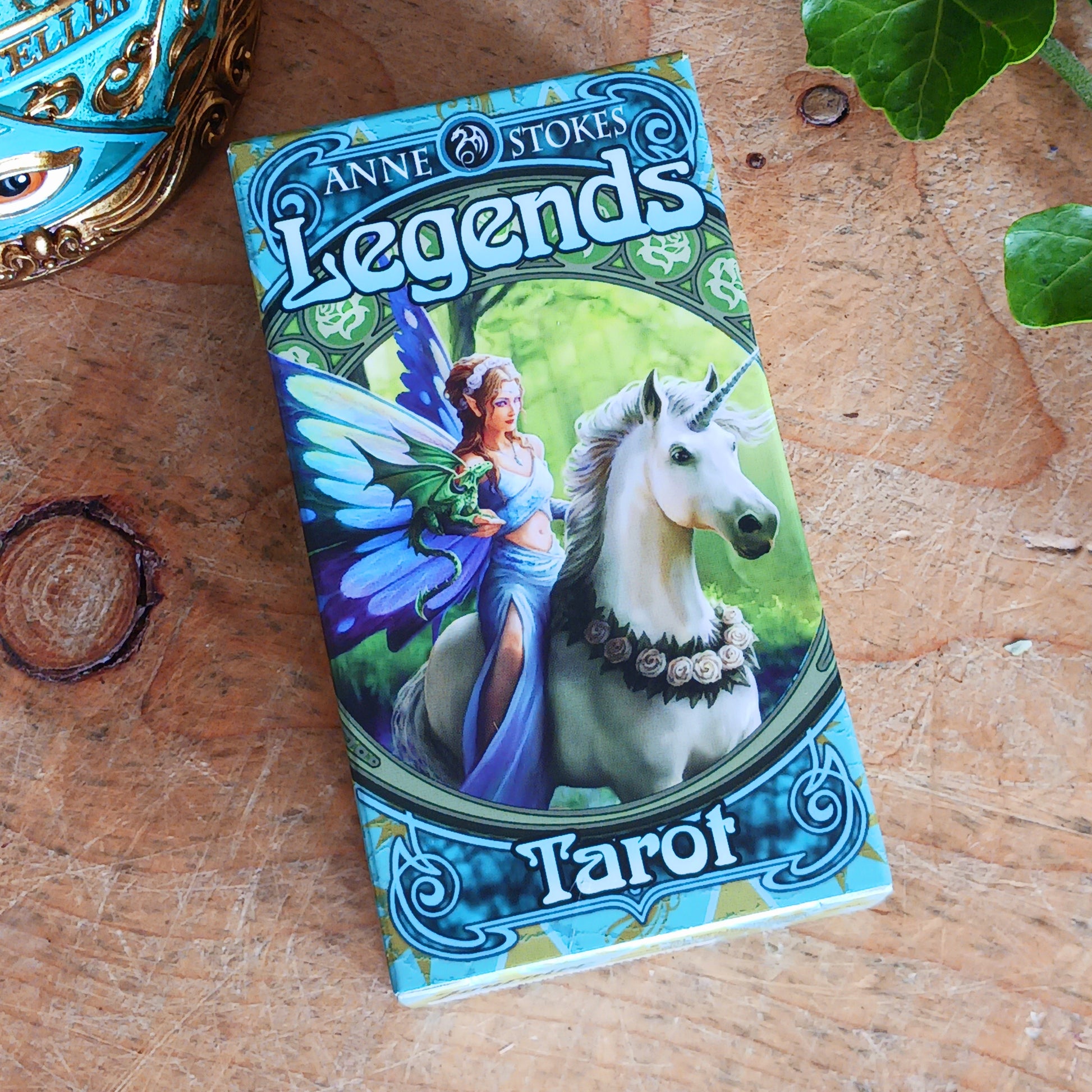 Step into a mystical world of magic and myth with The Legends Tarot Deck, featuring the captivating artwork of renowned fantasy artist Anne Stokes. This beautifully crafted deck includes 78 traditional tarot cards—22 Major Arcana and 56 Minor Arcana—each adorned with Anne’s enchanting illustrations of magical beings, mythical creatures, and otherworldly realms.