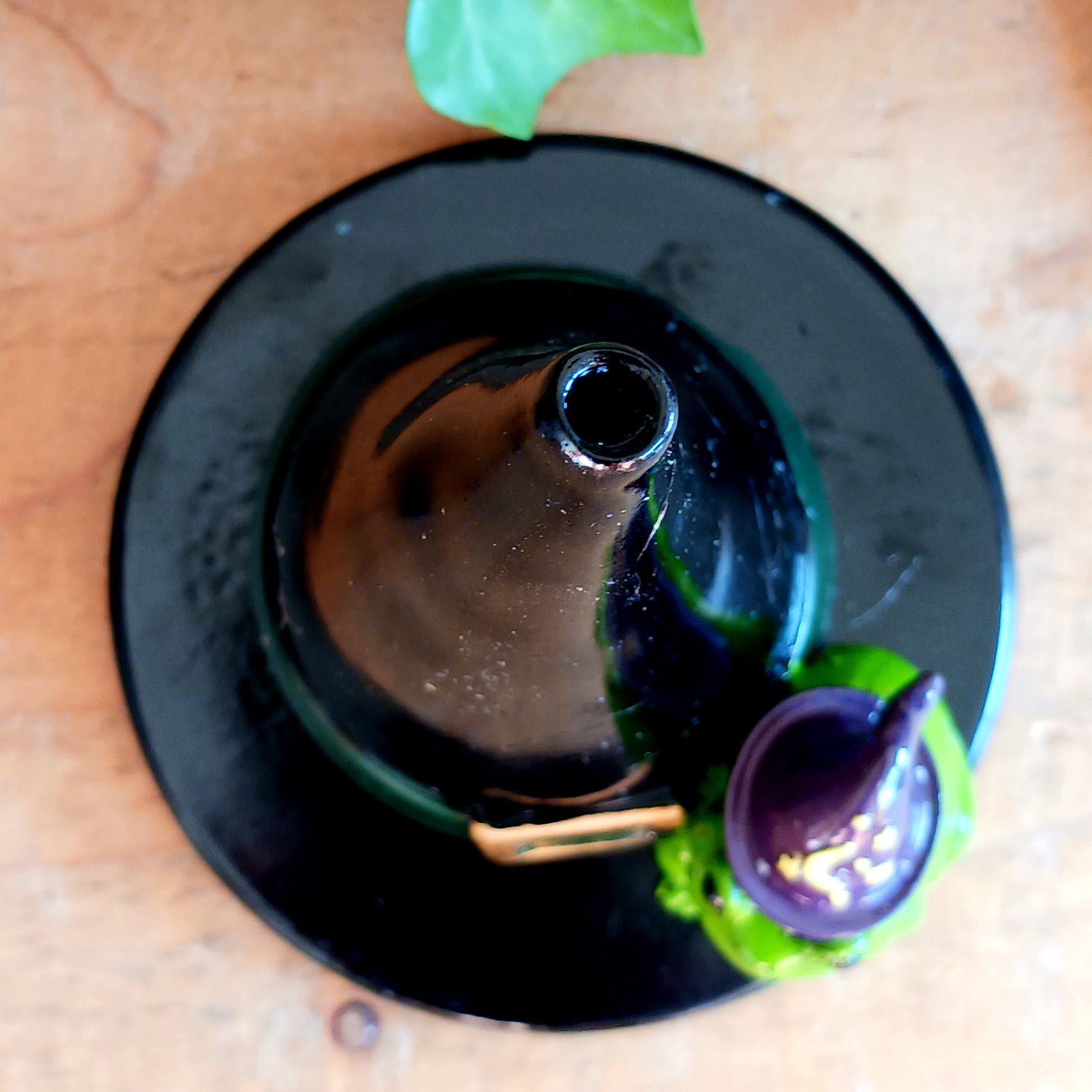 Add a touch of playful magic to your home with this charming Magic Toad & Witch Hat Incense Cone Holder. Made from resin, this quirky incense burner features a classic witch’s hat accompanied by a cute toad, creating a fun and mystical piece of witchy home décor.