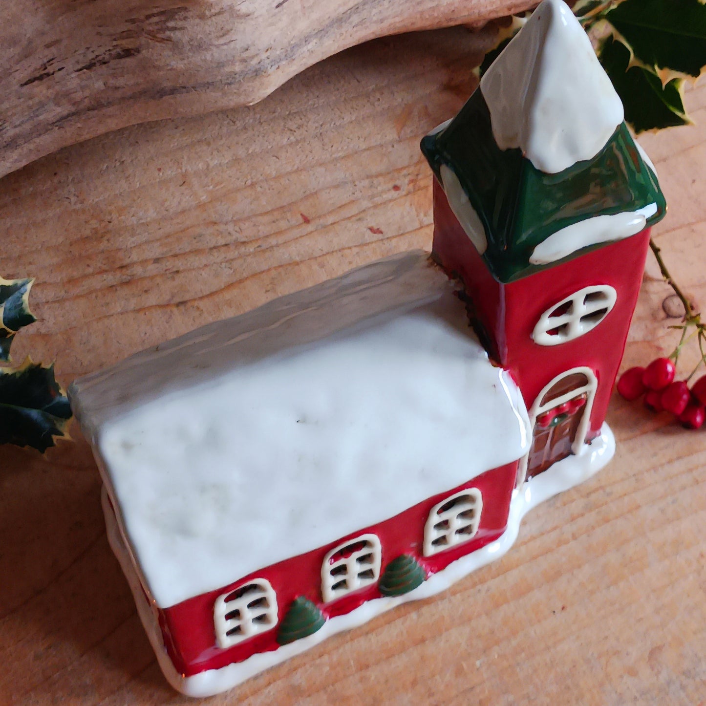 Bring festive warmth to your home with the Large Christmas Church Tealight Holder from the Village Pottery collection. This beautifully handcrafted ceramic piece features rustic detailing, evoking the charm of a snow-covered church glowing softly with candlelight.
