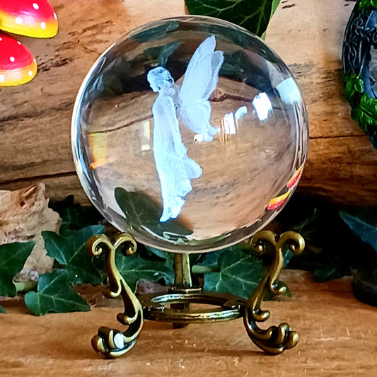 Capture a little woodland magic with this beautiful fairy crystal ball ornament, featuring an ethereal fairy figure delicately laser engraved inside a clear glass crystal ball. Displayed on an ornate antique-style stand, it makes a charming decorative piece for anyone who loves fairies, fantasy and magical woodland-inspired interiors.