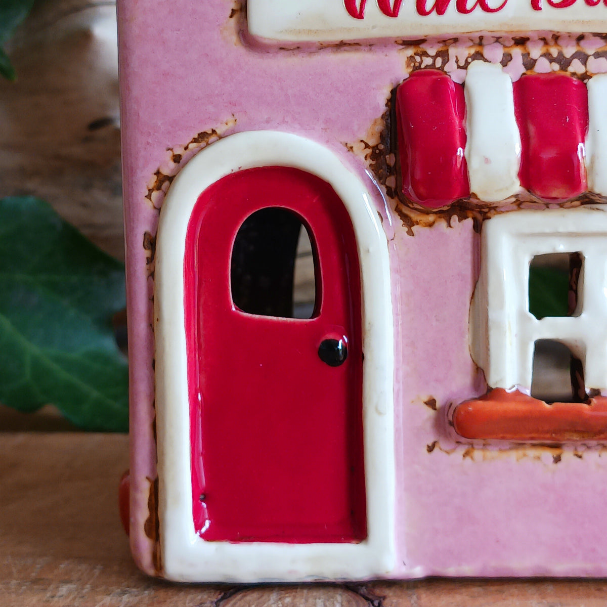 Bring the charm of a quaint village high street into your home with this delightful Village Pottery Wine Bar Tealight Holder. Hand-crafted from ceramic and beautifully hand-painted, this charming miniature wine bar is packed with character and intricate details.
